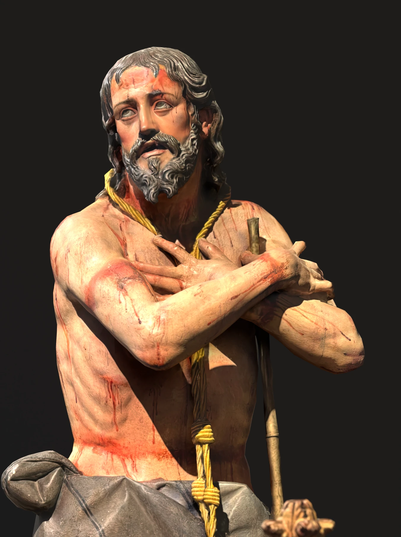 Detail of hands on a religious figure holding a cross