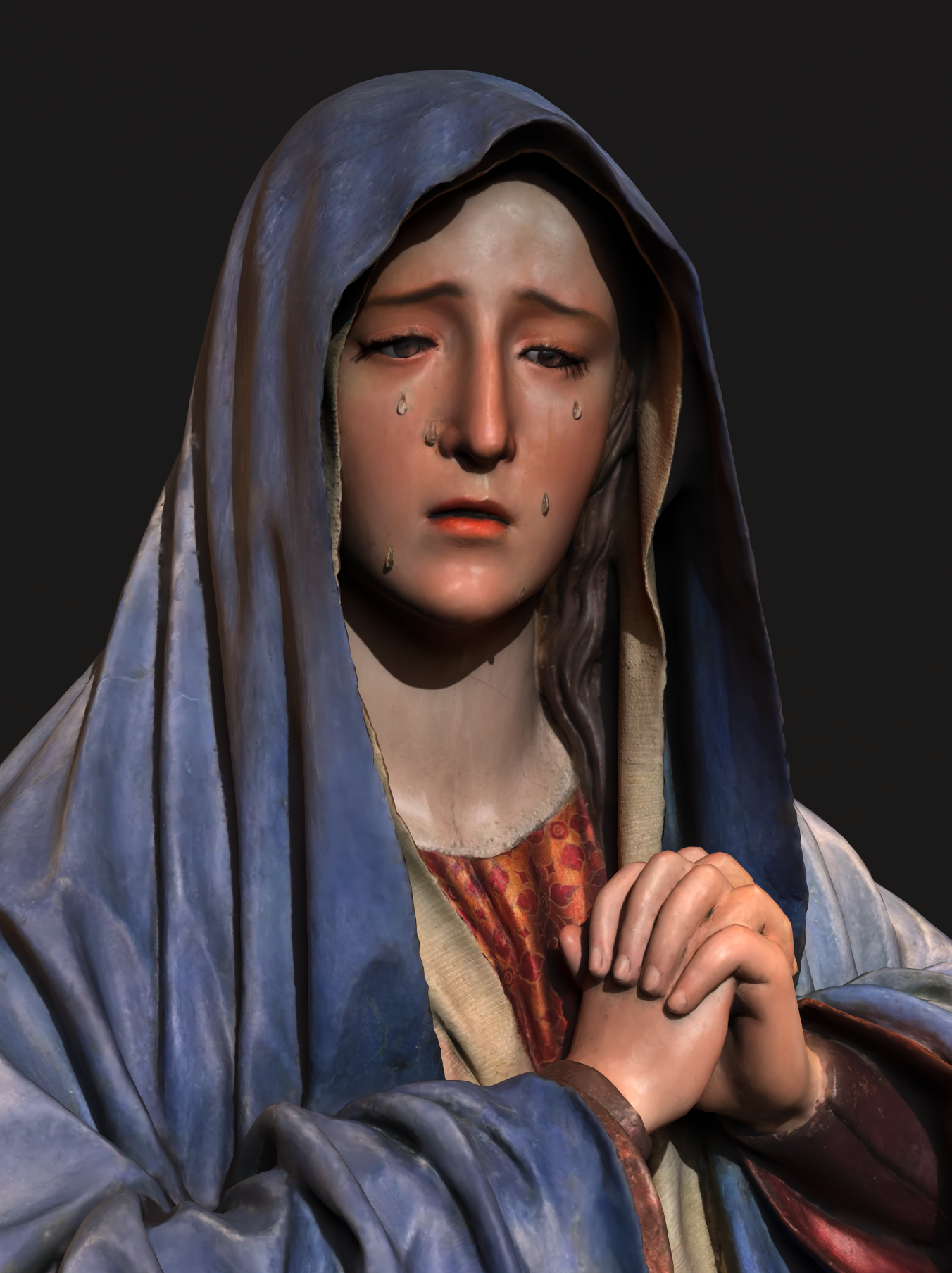 Mantle and face of a Virgin Mary sculpture with ornate silver details